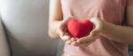 Woman holding red heart, love, health insurance, donation, happy