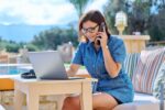 Middle age business woman using laptop outdoor.