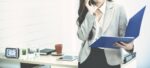 Business woman holding coffee cup and portfolio in office.