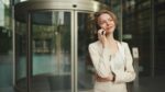 Close up, businesswoman talking on the cellphone on business center background
