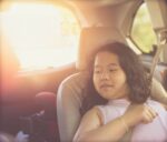 little Girl sit in car seat with belt in transportation safety protection